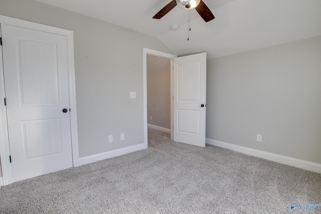 unfurnished bedroom with vaulted ceiling, ceiling fan, carpet, and baseboards