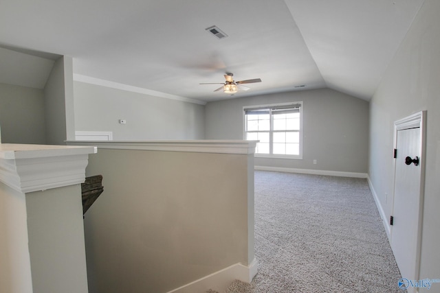 interior space with lofted ceiling, visible vents, carpet flooring, ceiling fan, and baseboards