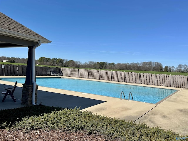 view of swimming pool with a fenced in pool, a patio area, and fence