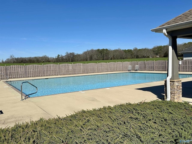 view of swimming pool featuring a patio area, fence, and a fenced in pool