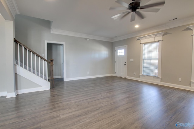 unfurnished living room with baseboards, a ceiling fan, dark wood-style floors, stairway, and ornamental molding