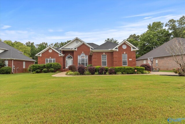 view of front of house with brick siding and a front yard