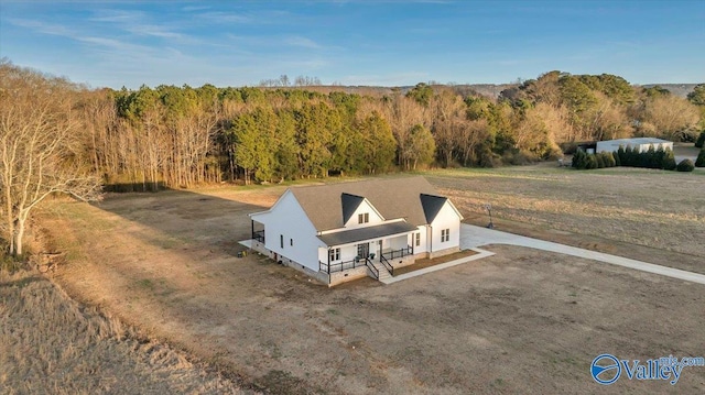 birds eye view of property featuring a wooded view