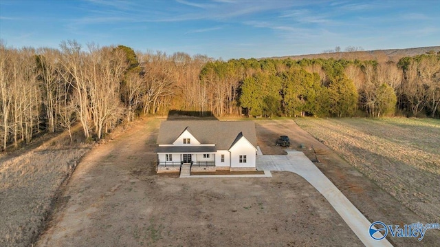 birds eye view of property with a wooded view