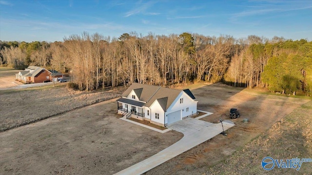 birds eye view of property with a view of trees