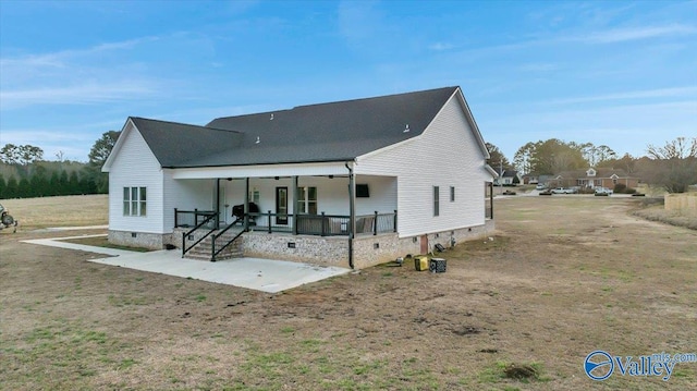 rear view of property with crawl space, a porch, and a patio