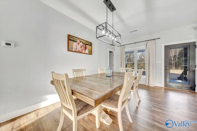 dining room with baseboards and wood finished floors