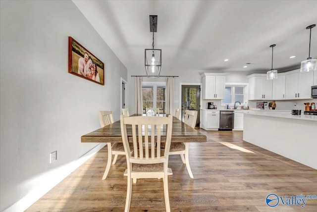 dining room with light wood finished floors and recessed lighting