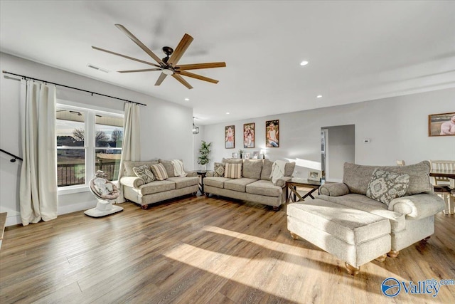 living area featuring ceiling fan, visible vents, wood finished floors, and recessed lighting