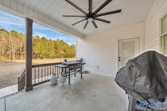 view of patio with outdoor dining space, area for grilling, and a ceiling fan