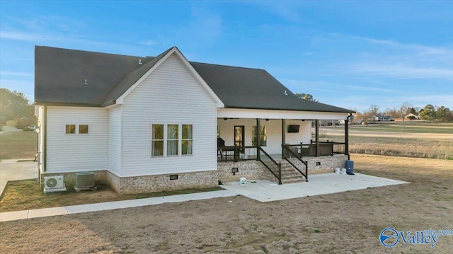 rear view of house with a patio, covered porch, central AC, crawl space, and ac unit