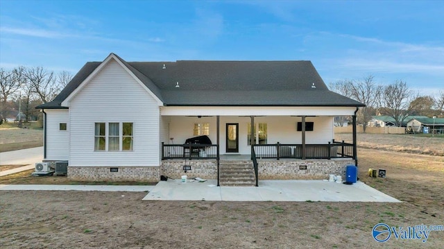 rear view of house featuring covered porch, a patio, crawl space, and ceiling fan