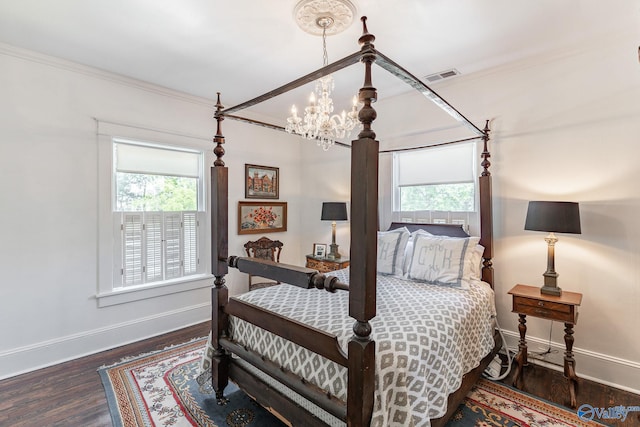 bedroom with multiple windows, a notable chandelier, crown molding, and dark hardwood / wood-style floors