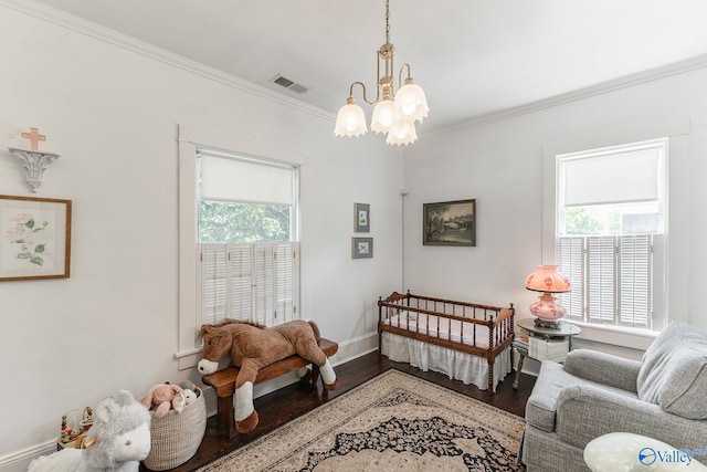 interior space with hardwood / wood-style flooring, ornamental molding, and an inviting chandelier