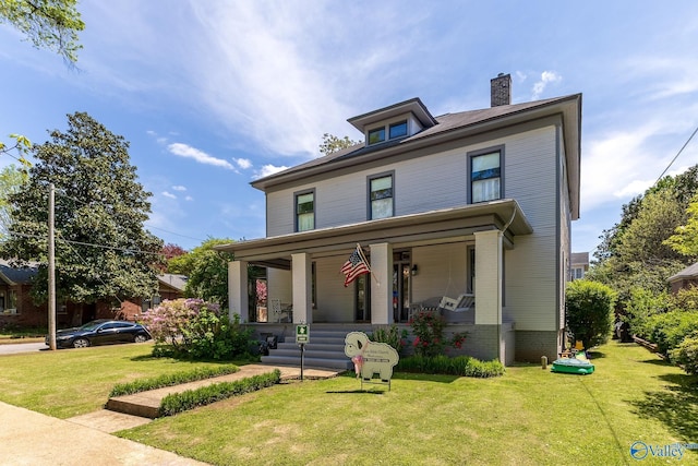 view of front of property with a porch and a front lawn