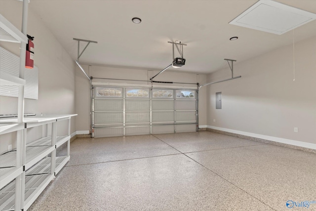 garage with a garage door opener and electric panel