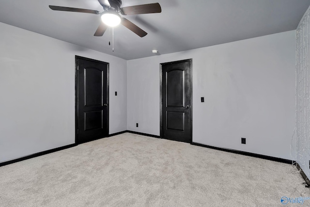 interior space with carpet flooring, baseboards, and a ceiling fan