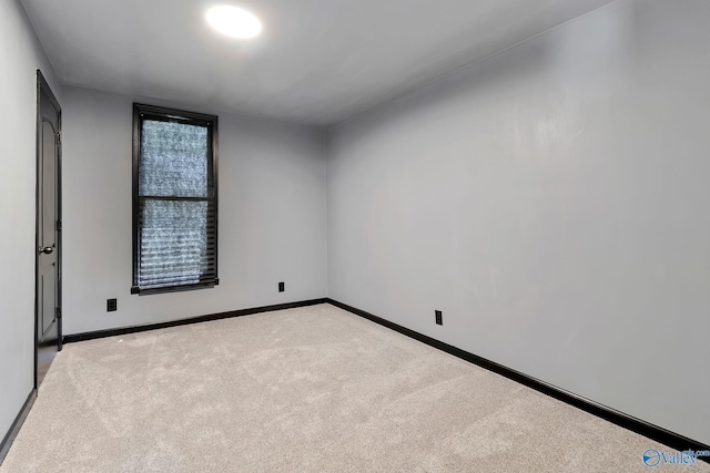 spare room with carpet flooring and baseboards