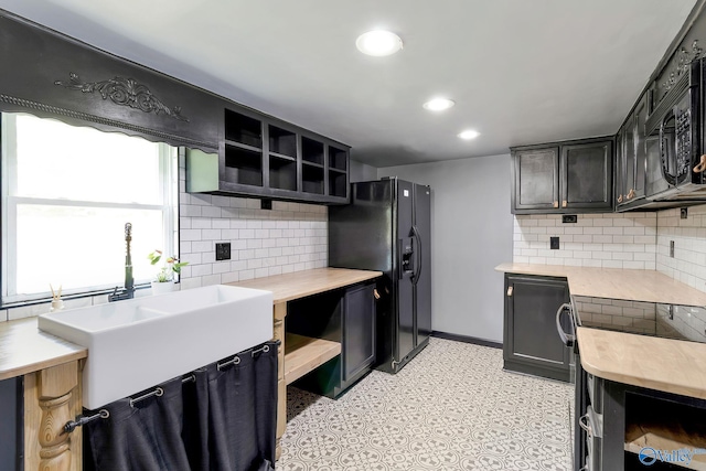 kitchen with open shelves, light countertops, black appliances, and backsplash