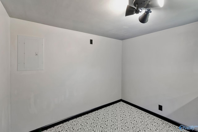 unfurnished room with electric panel and baseboards