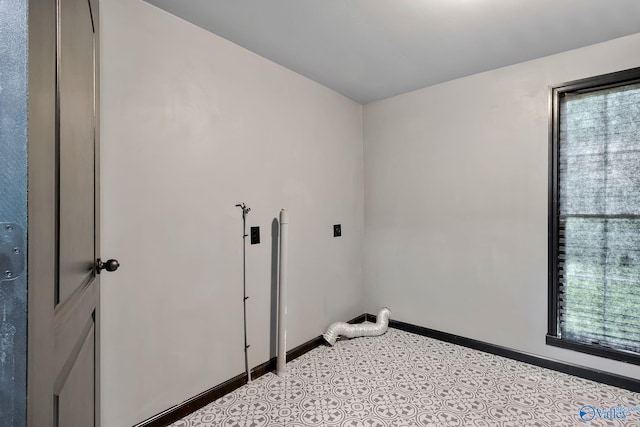 washroom featuring electric dryer hookup, baseboards, and laundry area