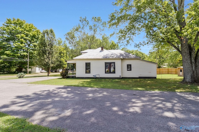 view of front of property with a front yard and fence