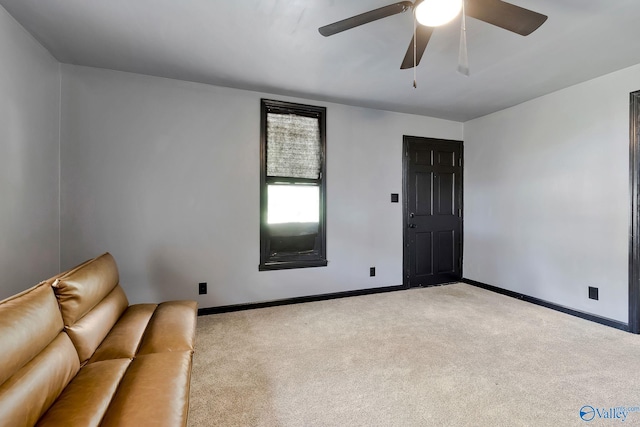 unfurnished living room with carpet flooring, a ceiling fan, and baseboards