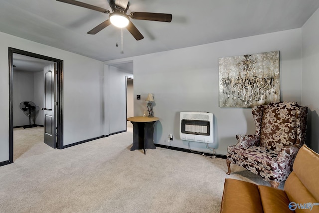 sitting room with carpet flooring, heating unit, baseboards, and ceiling fan