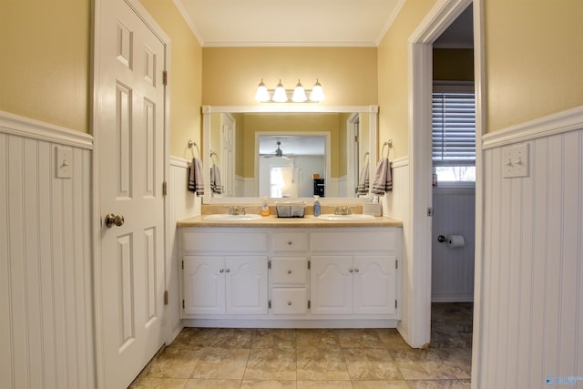 bathroom featuring vanity, ceiling fan, and crown molding