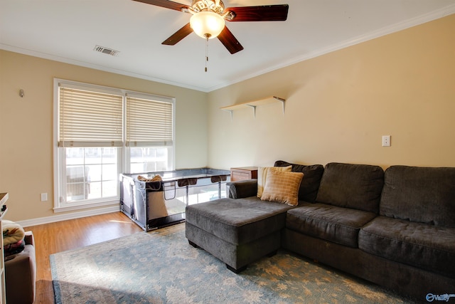 living room featuring hardwood / wood-style flooring, crown molding, and ceiling fan