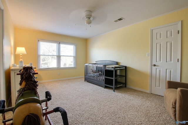 carpeted bedroom featuring crown molding and ceiling fan