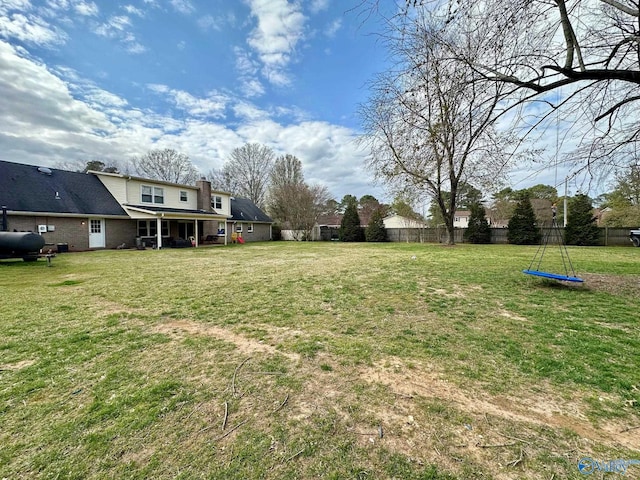 view of yard with fence and heating fuel