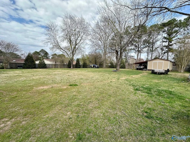 view of yard featuring a carport and an outdoor structure