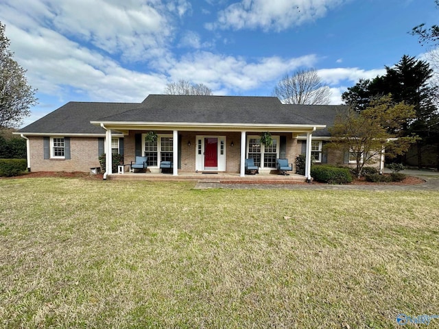 view of front of house with brick siding, a porch, and a front yard