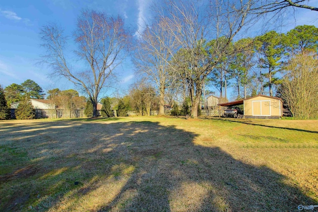 view of yard featuring a storage shed and a carport