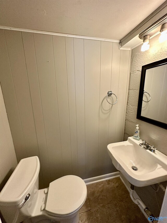 bathroom with tile patterned flooring, toilet, and sink