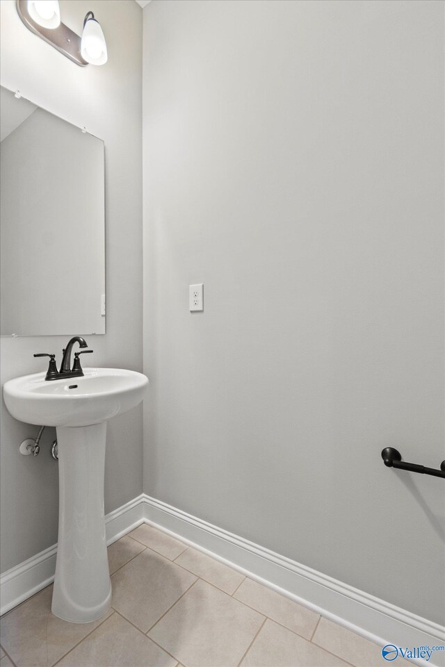 bathroom with tile patterned flooring and sink