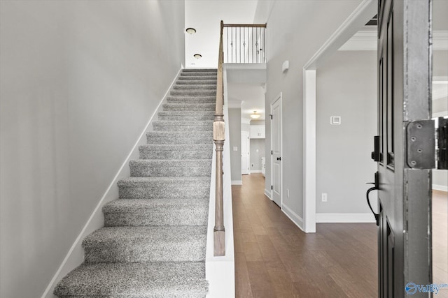 stairs with a high ceiling and hardwood / wood-style flooring