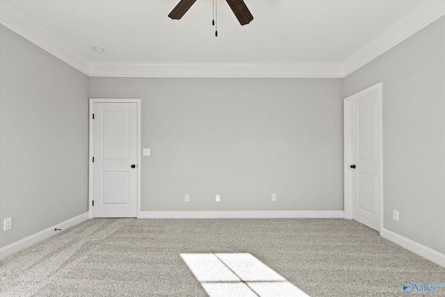 empty room with carpet flooring, ceiling fan, and ornamental molding