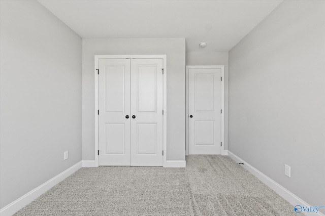 unfurnished bedroom with carpet and a closet