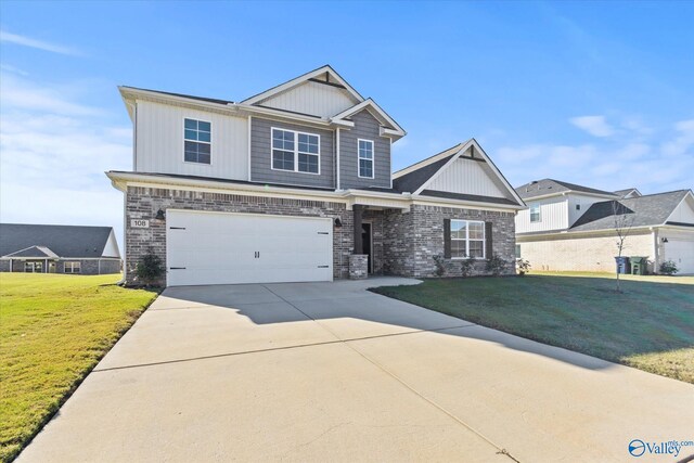 craftsman inspired home featuring a garage and a front lawn