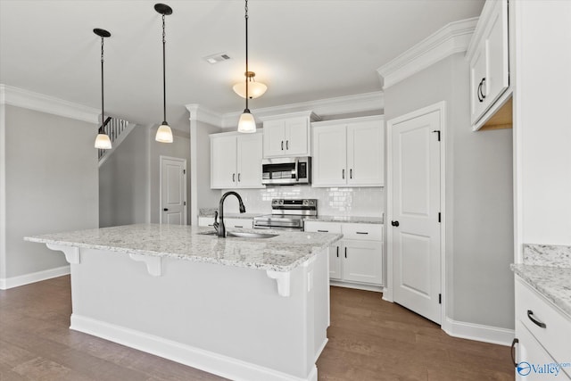 kitchen with white cabinets, an island with sink, and appliances with stainless steel finishes