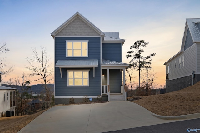 view of front of house featuring metal roof and a porch