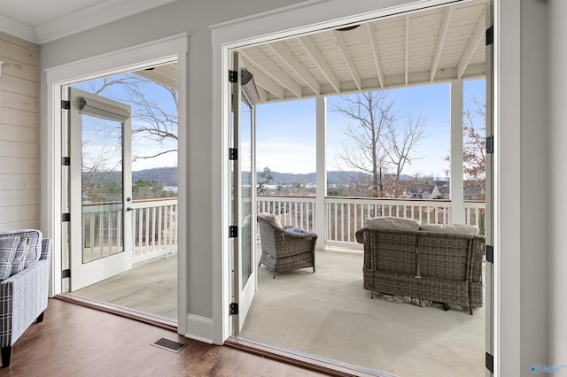 interior space with plenty of natural light, visible vents, a mountain view, and french doors