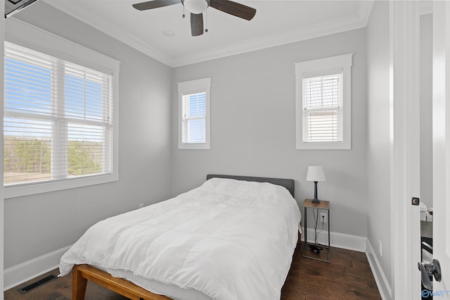 bedroom featuring multiple windows, visible vents, and crown molding