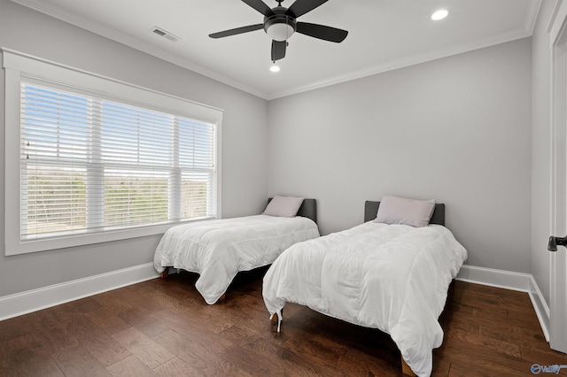 bedroom with dark wood-style floors, visible vents, ornamental molding, and baseboards