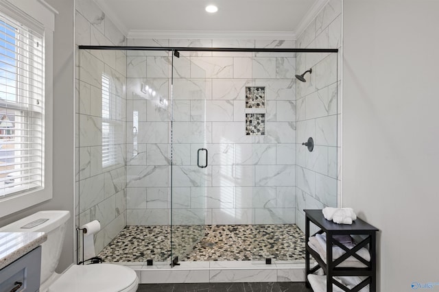 full bathroom featuring vanity, a shower stall, toilet, and crown molding