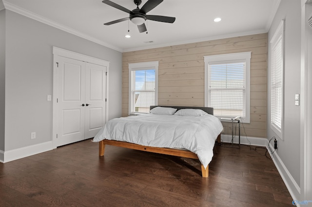 bedroom featuring baseboards, ornamental molding, and dark wood-type flooring