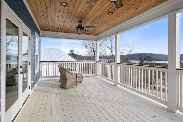 deck with a ceiling fan and french doors