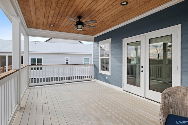 wooden terrace with ceiling fan and french doors